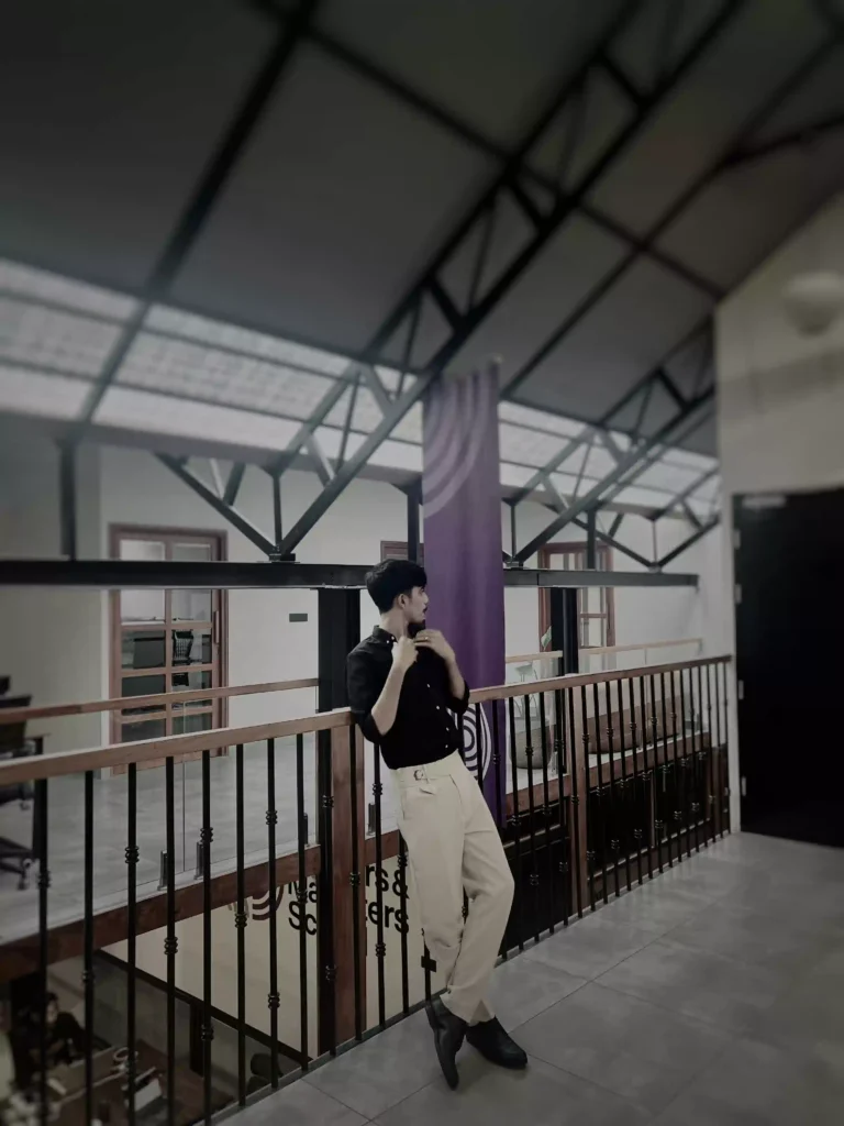 A young professional posing confidently in a modern office setting, representing a Digital Marketing Strategist in Kannur